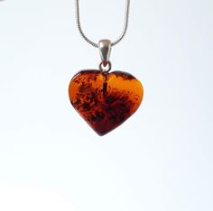 Baltic amber gemstone heart pendant. Small brown/ cognac amber heart pendant. Heart shaped jewelry. This natural Baltic amber heart shaped pendant been made of large amber stone that has been hand carved and polished into a beautiful heart. Pendant is  suitable for everyday wearing and special occasions. It is a talisman believed to bring  health, happiness and success in love. My items come inside a small box, ready for gift giving and perfect for storage. Length approximately  18mm / 0.7 inche Amber Heart Pendant Jewelry Gift, Heart Pendant Amber Jewelry For Gift, Heart-shaped Orange Jewelry For Gift, Orange Heart-shaped Jewelry Gift, Heart-shaped Amber Jewelry Gift, Heart-shaped Amber Jewelry For Gifts, Baltic Amber Pendant Necklace As Gift, Heart-shaped Brown Necklace For Gift, Heart-shaped Orange Necklace For Gift