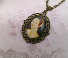 a necklace with an image of a woman on it