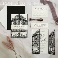 the wedding stationery is laid out on a marble table