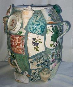 a ceramic vase with many different designs on it's body and sides, including the lid