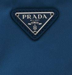 the prada logo is on top of a blue jacket