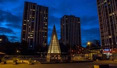 some very tall buildings in the city at night