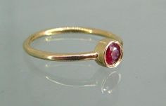 Elegant Stackable Ruby Birthstone Ring, Elegant Ruby Stackable Rings With Bezel Setting, Dainty Ruby Ring With Round Cut, Gold Stackable Rings With Ruby Bezel Setting, Minimalist Ruby Ring Birthstone, Minimalist Ruby Ring With Birthstone, Dainty Round Ruby Ring, Gift Yellow Gold Stackable Ruby Rings, Classic Ruby Stackable Rings With Gemstones