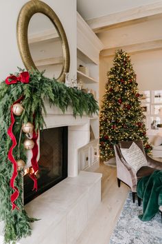 a living room with a christmas tree and fireplace