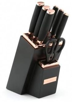 a set of knives sitting on top of a black holder