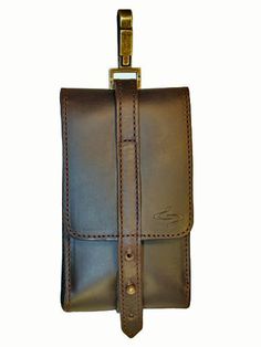 a brown leather case with a metal clip