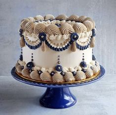 a white and blue cake sitting on top of a table