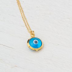 Tiny 14k solid gold round evil eye pendant. Dainty pendant. Great for everyday wear. Available with a solid 14k gold chain or as pendant only. The evil eye pendant is available in yellow gold and white gold with a blue eye and in yellow gold with a white eye. The blue eye is made of glass and the white eye of mother of pearl (mop). Chains are available in 3 lengths, 16inches/40cm, 18inches/45cm and 20 inches/50cm The pendant measures about 8mm / 1/3 inch (without the loop). Perfect gift for Vale Yellow Gold Evil Eye Round Pendant Necklace, 14k Gold Evil Eye Charm Necklace As Gift, 14k Gold Round Evil Eye Charm Necklace, 14k Gold Evil Eye Necklace With Round Pendant, 14k Gold Charm Necklace With Evil Eye, 14k Gold Evil Eye Round Necklace, 14k Gold Evil Eye Necklace, 14k Gold Evil Eye Charm Necklace With Round Pendant, 14k Gold Evil Eye Pendant Charm Necklace