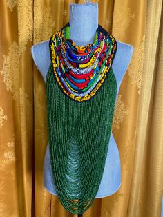 Handmade with perfection is the statement piece necklace, green sea beads adorned this piece along with corded African print mixed fabric collar. Hand tie for self adjusting... take up space when you make your entrance Green Large Beads Party Necklace, Green Multi-strand Beaded Necklaces For Festivals, Green Multi-strand Beaded Necklace For Festival, Green Large Beads For Party, Bohemian Green Necklace, Green Bohemian Beaded Necklaces For Party, Bohemian Green Beaded Necklaces For Party, Bohemian Green Beaded Necklace For Party, Green Multi-strand Festival Necklaces