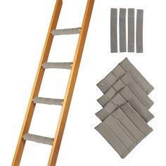 a wooden ladder next to several pieces of cloth