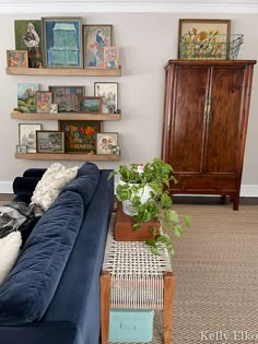 a living room filled with furniture and lots of pictures on the wall above it's couch