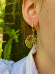 Add a touch of enchantment to your fall wardrobe with these stunning gold-filled dangle earrings made of resin, featuring real acorn, fern, and oak leaf accents. These unique pieces are the perfect accessory for the autumn season, making them an ideal gift for Thanksgiving or as a thoughtful hostess gift. Embrace your inner forest witch with these Mori Kei inspired forest jewelry pieces, which are also a wonderful gift for a teacher, daughter, friend, or girlfriend. Bring a little piece of the f Nature-inspired Resin Jewelry, Nature-inspired Dangle Hoop Earrings For Gift, Nature-inspired Dangle Hoop Earrings As Gift, Nature-inspired Dangle Hoop Earrings, Nature-inspired Drop Earrings With Birth Flower, Nature-inspired Birth Flower Drop Earrings, Gold Resin Nature-inspired Jewelry, Nature-inspired Gold Resin Jewelry, Nature-inspired Dangle Flower Earrings