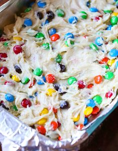 a cake covered in white frosting with lots of candy