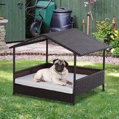 a pug dog laying in an outdoor pet bed