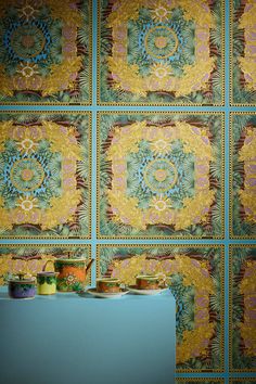 the wall is decorated with colorful patterns and colors, including blue, green, yellow, orange