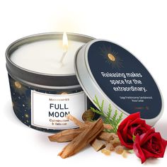 a candle that is next to some cinnamons and a rose on a white surface