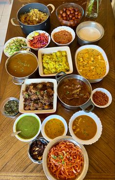 a table topped with lots of different types of food and bowls on top of it