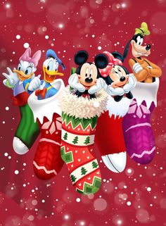 mickey mouse and friends christmas stockings hanging from the ceiling with snow falling down on them