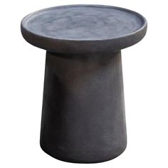 a small gray table with a black base on it's side, against a white background