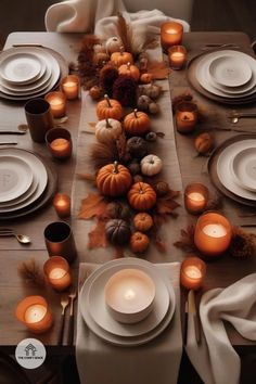 the table is set with white plates and candles