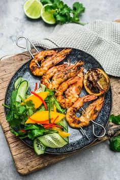 grilled shrimp and vegetables on a black plate