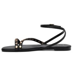 Strap on the adorable Farra flat sandals and step into your day with style! These simple yet chic sandals feature a cute design and an adjustable ankle strap, ensuring a perfect fit for all day comfort. The straps are carefully embellished with round studs, adding a blingy twist that elevates the overall look. Versatile and fashionable, the Farra flat sandals pair effortlessly with everything from casual outfits to sundresses, making them a must have addition to your summer wardrobe. Black T-strap Sandals With Adjustable Strap For Spring, Black Flat Synthetic T-strap Sandals, Adjustable Black T-strap Sandals For Beach, Closed Toe Wedges, Black Synthetic Flat T-strap Sandals, Low Block Heel Sandal, Ankle Strap Sandals Flat, Black Adjustable T-strap Sandals With Buckle Closure, Chic Sandals