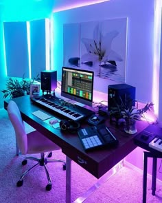 a desk with a keyboard, mouse and monitor on it in front of some plants