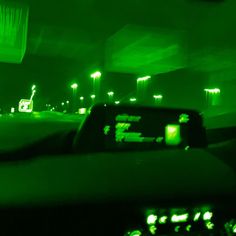 the interior of a car at night with green lights