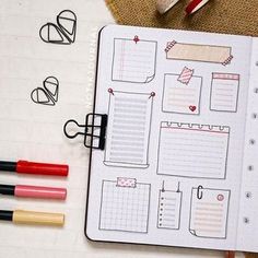 an open planner with markers and pens on it