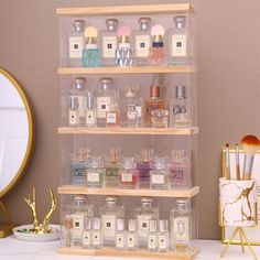 an assortment of perfumes on display in front of a mirror and other items next to it