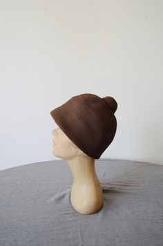 "A dark brown hat meant to look like a riding helmet. Label is Danciger. Excellent shape! Just fits around the crown of a 22\" head but would be a little less snug on smaller and fit farther down the head as shown. Follow along on instagram @lovecharlesvintage" Retro Brown Hat Bands For Winter, Fitted Retro Brown Cloche Hat, Adjustable Brown Bonnet Cap, Winter Brown Bonnet With Curved Brim, Winter Brown Cloche Hat, Vintage Brown Hat Band For Winter, Vintage Brown Hat Bands For Winter, Vintage Fitted Beanie Hat, Brown Hat Bands For Winter, One Size Fits Most