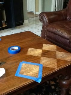 a coffee table with tape on it next to a couch