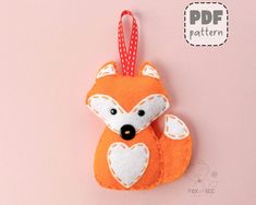 an ornament shaped like a fox on a pink background