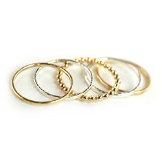 "Stylish Mixed Hammered Stackable Rings Set of 5. Sterling silver and 14k gold-fill metal is forged and hammered to create this textural look. Layer all these beautiful Aquarian Thoughts rings together or wear them one by one. Listing includes a mixture of 2 \"Tree Bark\" Stacking Rings (1 GOLD & 1 SILVER), 2 \"Finely\" Hammered Stacking Rings (1 GOLD & 1 SILVER) and 1 GOLD Beaded Stacking Ring. Select ring size from drop down menu or contact us for custom requests. Ring bands measures a Elegant Hammered Stackable Rings, Gold Hammered Stackable Rings, Hammered Recycled Gold Stackable Rings, Classic Hammered 14k Gold Stackable Rings, Hammered Yellow Gold Stackable Rings In Sterling Silver, Beaded Stacking Rings, Gemstone Stacking Ring, Birthstone Stacking Rings, Stackable Ring Sets