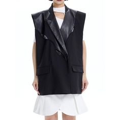 Discover the Epitome of Sophistication and Style Embrace the latest trend in women's fashion with our exclusive Wide-Shoulder V-Neck PU Leather Patchwork Waistcoat. This stunning piece is a perfect blend of style and comfort, designed to elevate your wardrobe. It's not just a waistcoat; it's a fashion statement that embodies elegance and confidence. Its unique three-dimensional design and wide shoulder cut create a bold, modern look that stands out. Product Features High-Quality Material: Crafted with a blend of Cotton, Polyester, and Polyamide, ensuring both comfort and durability. Elegant Design: Features a stylish V-neck and a single-button closure, adding a touch of class to your outfit. Versatile Pattern: The patchwork design combines PU leather and fabric, making it a versatile piece Chic Black Leather Vest, Punk Style Sleeveless Leather Vest, Luxury Leather Sleeveless Vest, Black Leather Sleeveless Vest, Sleeveless Biker Leather Vest, Leather Patchwork, Office Fashion Women, Shoulder Cut, Office Ladies