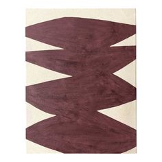 a rug with an abstract design in maroon and white colors on the floor, it is made out of wood