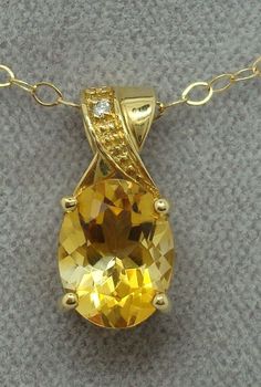 "All of our jewelry is guaranteed authentic by our Graduate Gemologist of the Gemological Institute of America (GIA). 14k Yellow Gold Oval Genuine Natural Citrine Pendant with Diamonds (#J512) 14k yellow gold pendant featuring an oval citrine and small diamond accents. The citrine is a pretty lemon yellow color. The pendant measures 5/8\". Also includes a new 18\" 14k yellow gold chain. This is a contemporary piece. Pretty! Inventory#DC2749. SKU#J512. 100% Satisfaction Guaranteed!" Luxury Yellow Gold Necklaces With Natural Stones, Luxury Citrine Oval Pendant Jewelry, Luxury Yellow Necklaces With Large Pendant, Luxury Recycled Gold Necklace With Oval Pendant, Yellow Oval 14k Gold Necklace, Yellow 14k Gold Oval Necklace, Oval 14k Gold Yellow Necklace, Oval Yellow 14k Gold Necklace, Yellow 14k Gold Oval Jewelry