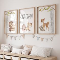 three framed pictures hang on the wall above a wooden bench with pillows and pillow cases