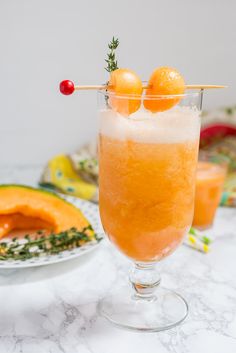 a glass filled with orange juice and garnished with fruit