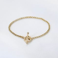 "14K GoldToggle Rolo Chain Bracelet - 14K Gold 2mm Rolo Chain Bracelet ★ 14K gold 2mm rolo chain ★ 14K gold toggle clasp ★ All components are 14K solid yellow gold The length includes the chain and the closure. Please measure your wrist before you place your order. ** How to choose a correct size of bracelet. 1. Measure your wrist below the wrist bone using a flexible tape measures, a string or a strip of paper. 2. If using a string or a strip of paper, mark length. Then, measure it with a ruler Everyday Yellow Gold Chain Bracelet With Toggle Clasp, Elegant Gold-plated Chain Bracelet With Toggle Clasp, Yellow Gold Plated Bracelet With Toggle Clasp, Elegant Gold Link Bracelet With Toggle Clasp, Yellow Gold-plated Bracelet With Toggle Clasp, Classic Yellow Gold Bracelet With Toggle Clasp, Classic Gold Bracelet With Toggle Clasp, Elegant Round Chain Bracelet With Toggle Clasp, Everyday Yellow Gold Bracelets With Toggle Clasp