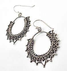 Mandala filigree sterling silver Indian silver drop hoop earrings. Good used condition with little to no signs of normal wear. Handmade soldering features. Beautiful patina. Acid tests positive for sterling silver. Earrings measure 1 and 3/4ths of an inch tall and 1 and 1/4 of an inch wide. Small Hoop Sterling Silver Pierced Earrings, Sterling Silver Small Hoop Pierced Earrings, Bohemian Sterling Silver Teardrop Plug Earrings, Bohemian Teardrop Sterling Silver Plug Earrings, Sterling Silver Dangle Jewelry With Intricate Design, Sterling Silver Hoop Earrings Stamped 925, Sterling Silver Oxidized Hoop Earrings, Sterling Silver Hoop Earrings With Oxidized Finish, Pierced Antique Silver Sterling Jewelry