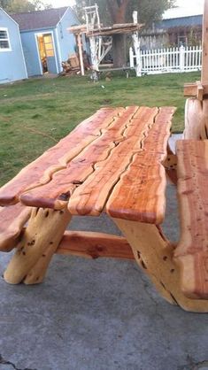 a wooden bench sitting on top of a cement ground