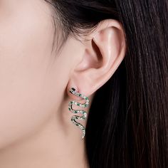 The snake is one of the oldest and most widespread mythological symbols, a symbol of transformation, rebirth and immortality. Crafted in sterling silver, each earring is set with glittering white stones as skin and decorated with green stones to add its spark. If you are interested in snake jewelry, just add this pair of earring to your jewelrybox.Carat Weight: 2.286 ctStone Size: 1.5,1,1.5,1.3,1,1.5*3 mmStone Type: Jeulia® StoneNumber of Stones: 92 Stone Color: Emerald Green, Diamond WhiteStone Silver Snake Shape Earrings, Elegant Snake Shape Earrings With Ear Wire, Silver Snake-shaped Pierced Earrings, Sterling Silver White Gold Snake-shaped Jewelry, Sterling Silver Snake-shaped White Gold Jewelry, Sterling Silver Snake Shape Jewelry In White Gold, Silver Snake-shaped Earrings, Silver Snake-shaped Earrings For Pierced Ears, Elegant Sterling Silver Snake Jewelry