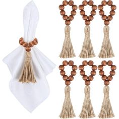 wooden beads and tassels tied together on white napkins next to each other