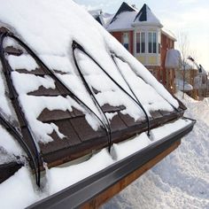 the roof of a house covered in snow