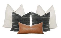 three pillows and one pillow are sitting next to each other on a white background with black stripes