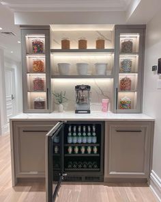 an open refrigerator in the middle of a room with shelves full of food and drinks