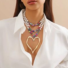 Glam Layered Necklace In Multicolor Beads And White Faux Pearls With A Large Gold Heart Pendant. Boutique Packaging Includes Storage Bag New To Poshmark? Use Code Emmiesbling For $10 Off Your Purchase When You Open A New Account. Check Out My Other Listings If You Like Boho Hippie 60’s 70’s 80’s 90’s Y2k Retro Mcm Pin-Up Beach Western Pool Coachella Festival Southwestern Bohemian Vintage Ig Instagram Tik Tok Gypsy Spell Vici Nasty Gal, Misguided, House Of Cb, Quay, Windsor, Lulus, H&M, Forever 2 Estilo Boho Chic, Heart Shaped Necklace, Multi Layer Necklace, Neck Jewellery, Styl Boho, Heart Shape Pendant, Chain Choker Necklace, Vintage Heart, Colourful Necklace