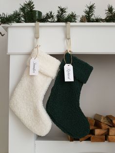 two christmas stockings hanging on a mantle