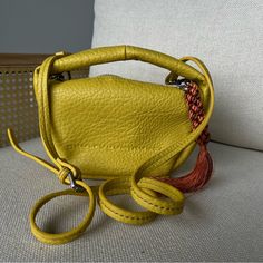 Original Bag From The Store Never Worn Perfect Condition Leather Unique Detailed Tassel In The Side Luxury Yellow Crossbody Satchel, Yellow Shoulder Bag With Double Handle, Luxury Yellow Bucket Bag For Daily Use, Luxury Yellow Bucket Bag For Shopping, Luxury Yellow Bucket Bag For Travel, Luxury Yellow Rectangular Bucket Bag, Luxury Yellow Bucket Bag With Removable Pouch, Yellow Top Handle Bucket Bag For Travel, Luxury Yellow Crossbody Shoulder Bag